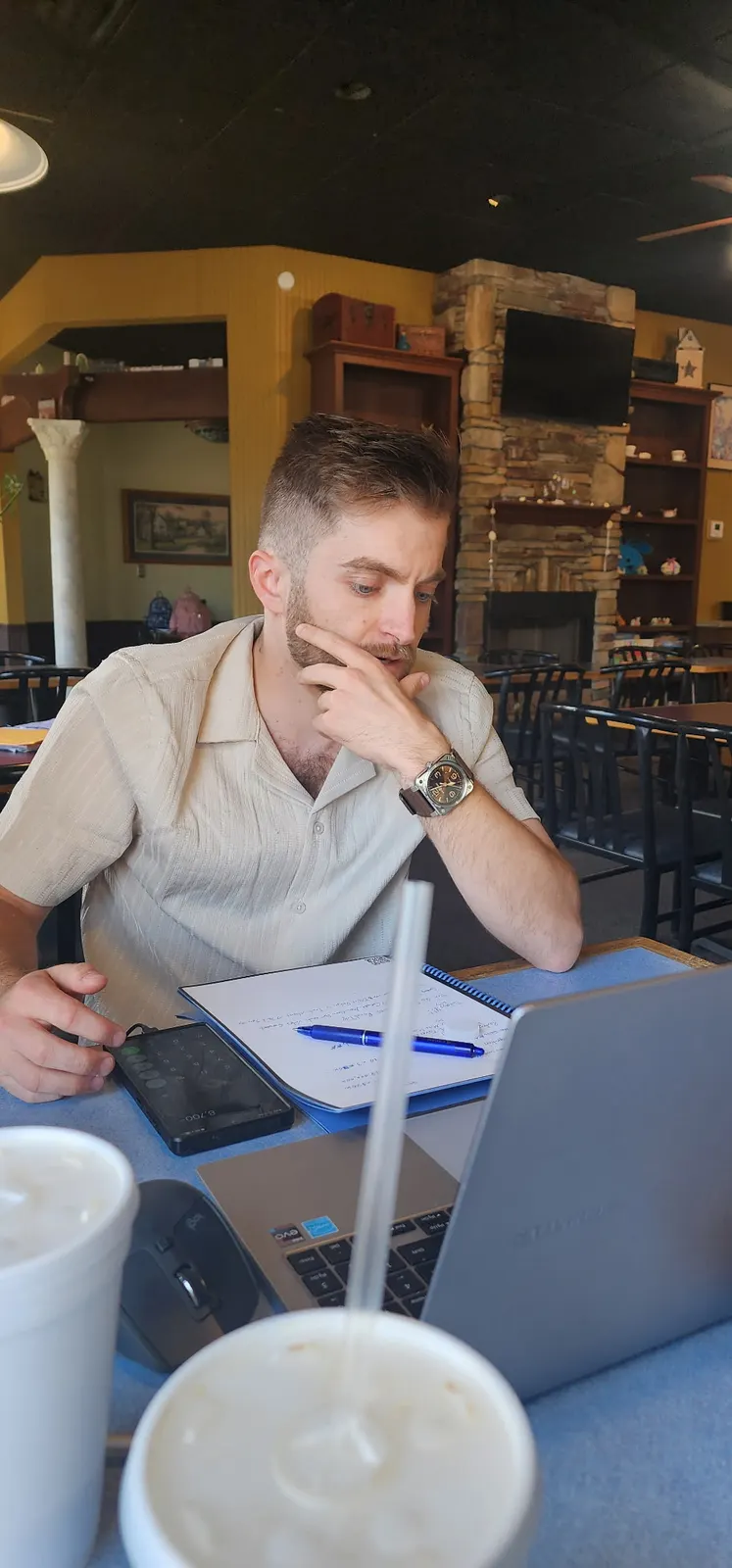 Roofory founder Noah Williams working at a table on the road