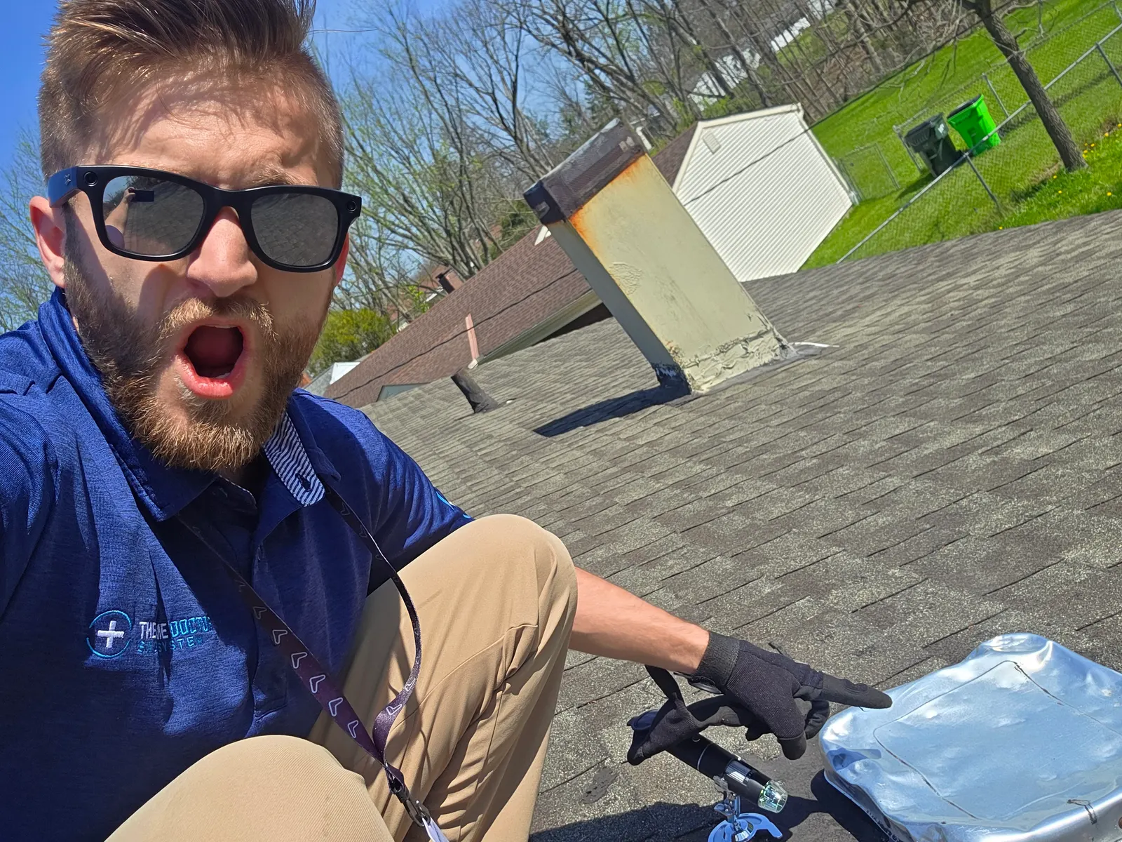 Roofer on a shingle roof checking for hail damage