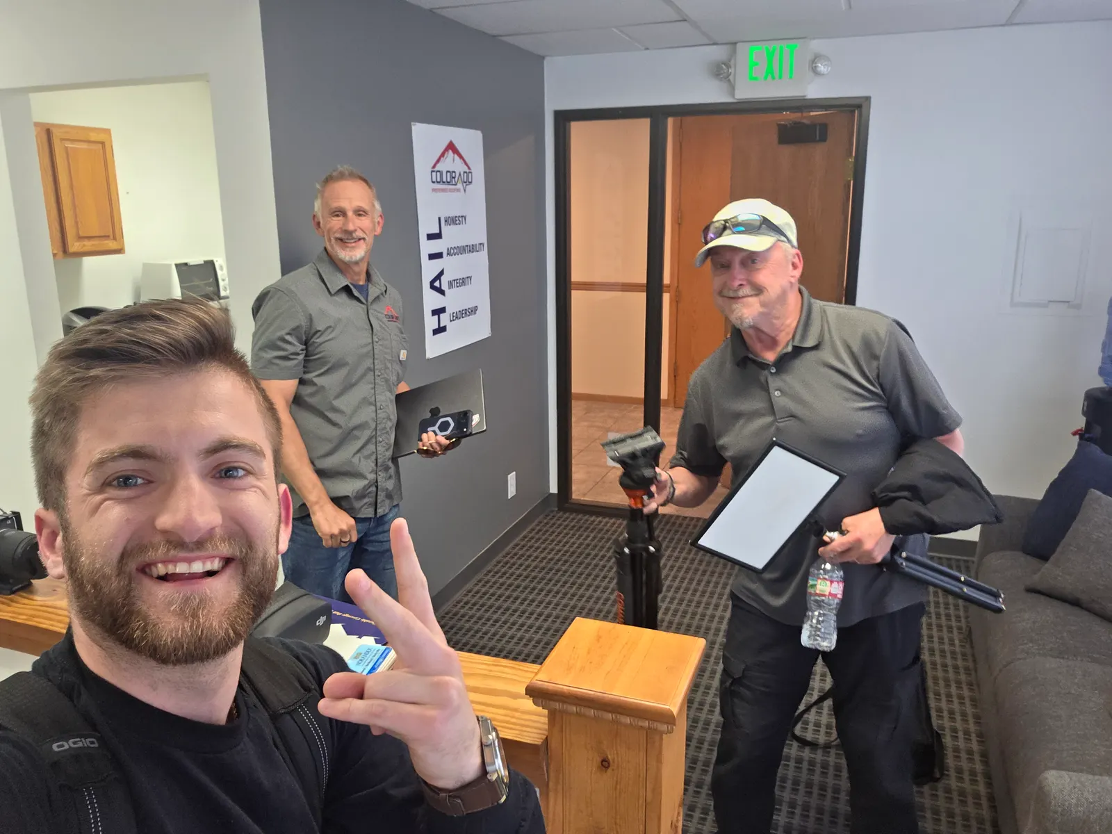 Noah Williams with roofing company owners at their office