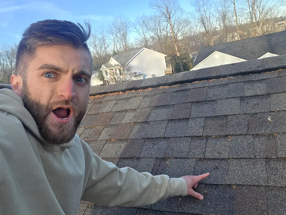 Noah on a hail-hit roof, April 2026.